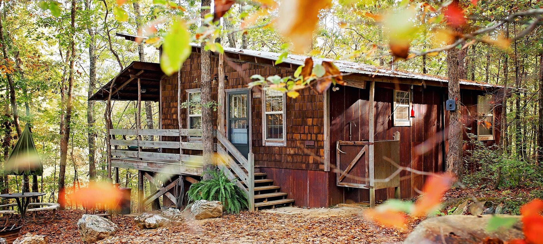 Beautiful exterior view of the cabin in the fall surrounded by colorful trees